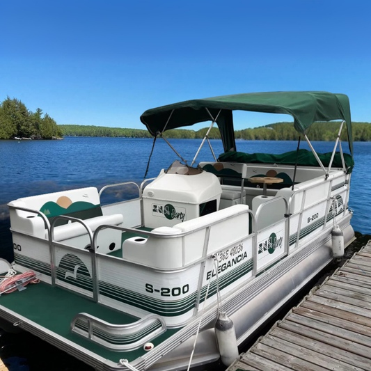 Pontoon boat on a dock with a clear blue sky and water background
